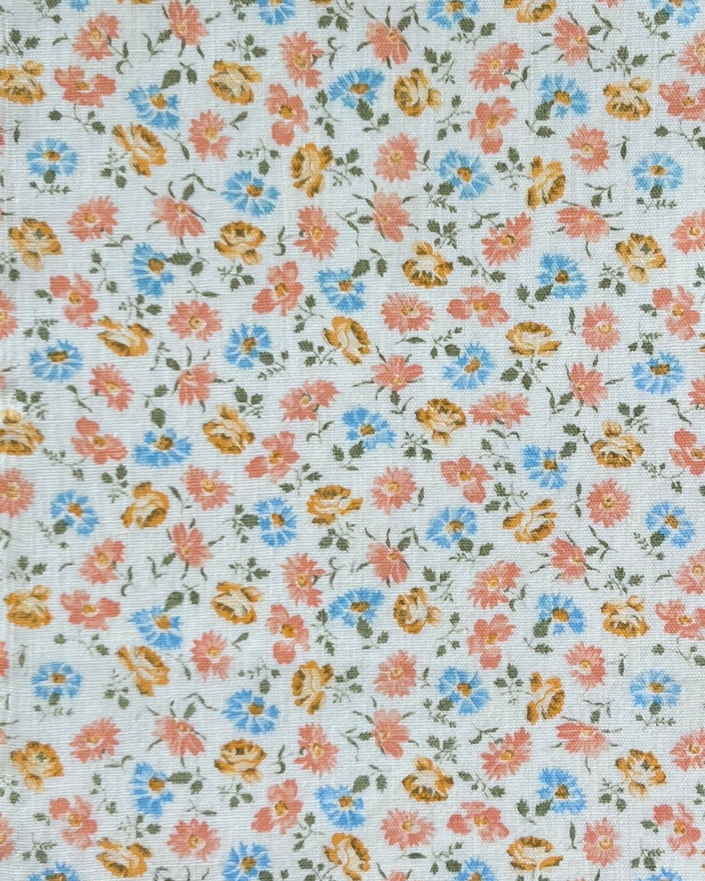 Elle boheme fabric pattern of small wildflowers in pastel colours on a vintage white cream background